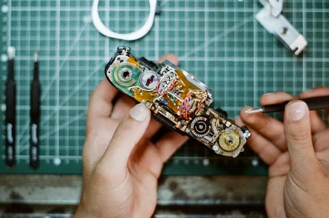 Réparation appareil photo canon AE-1 argentique démonté – Service garanti atelier France